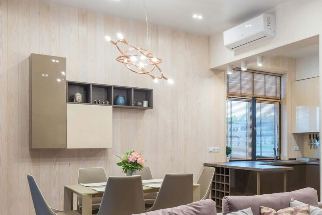 Modern living room and dining area with elegant decor and ample natural light.